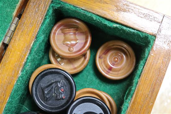 A bone travelling chess set and counters